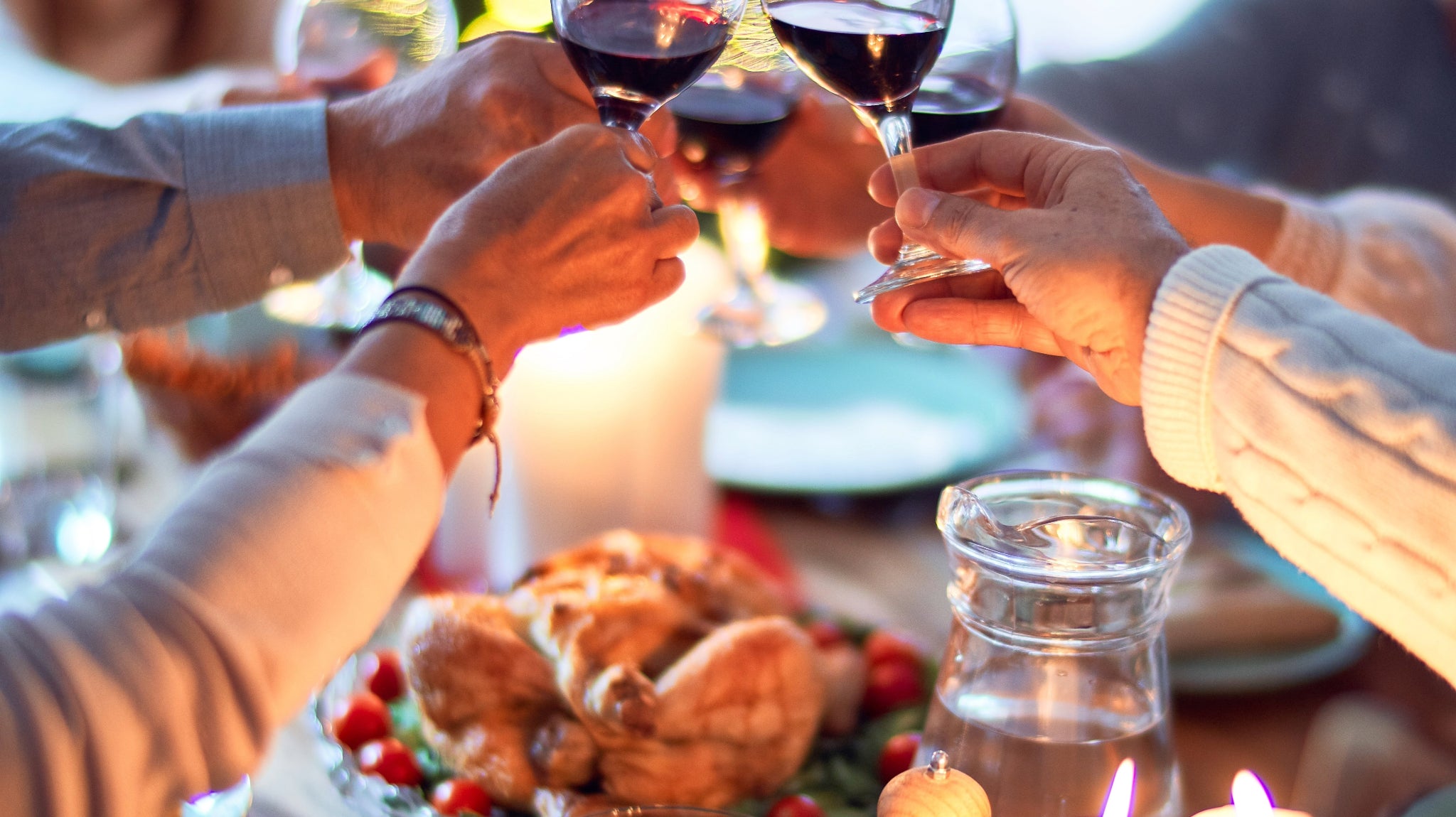 Group of people cheering with wine glasses.