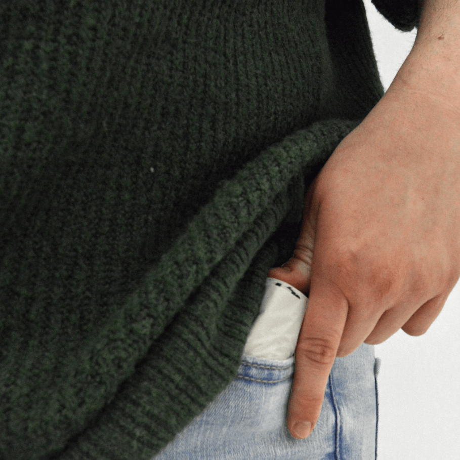 Person putting a roll of MyEcoWorld poop bags into their pocket.