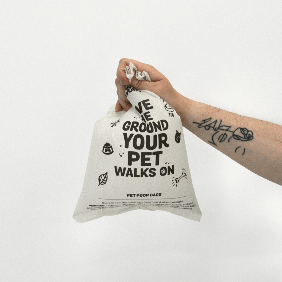 Hand holding MyEcoWorld poop bag filled with air.