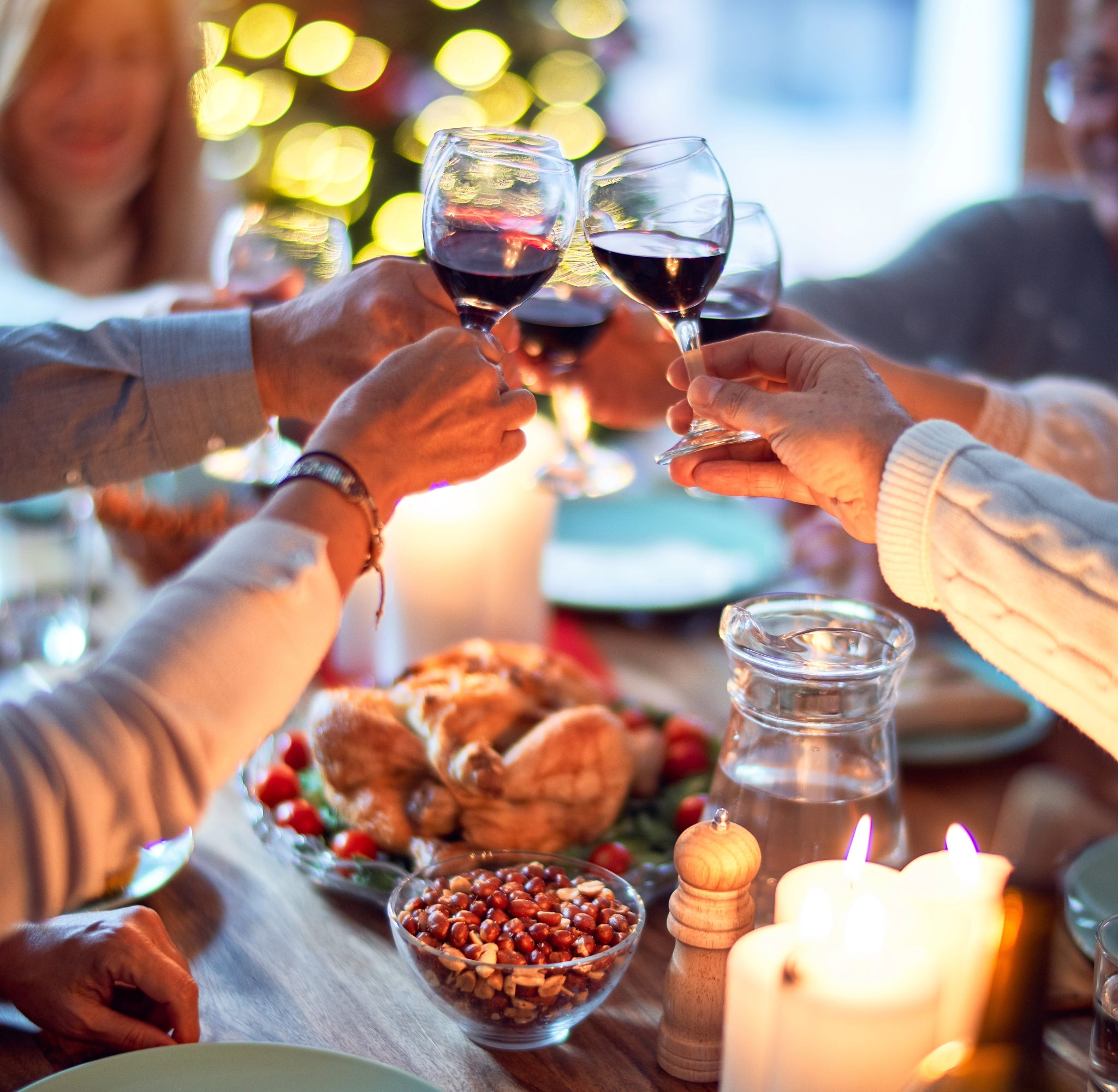 Group of people cheering with wine glasses.