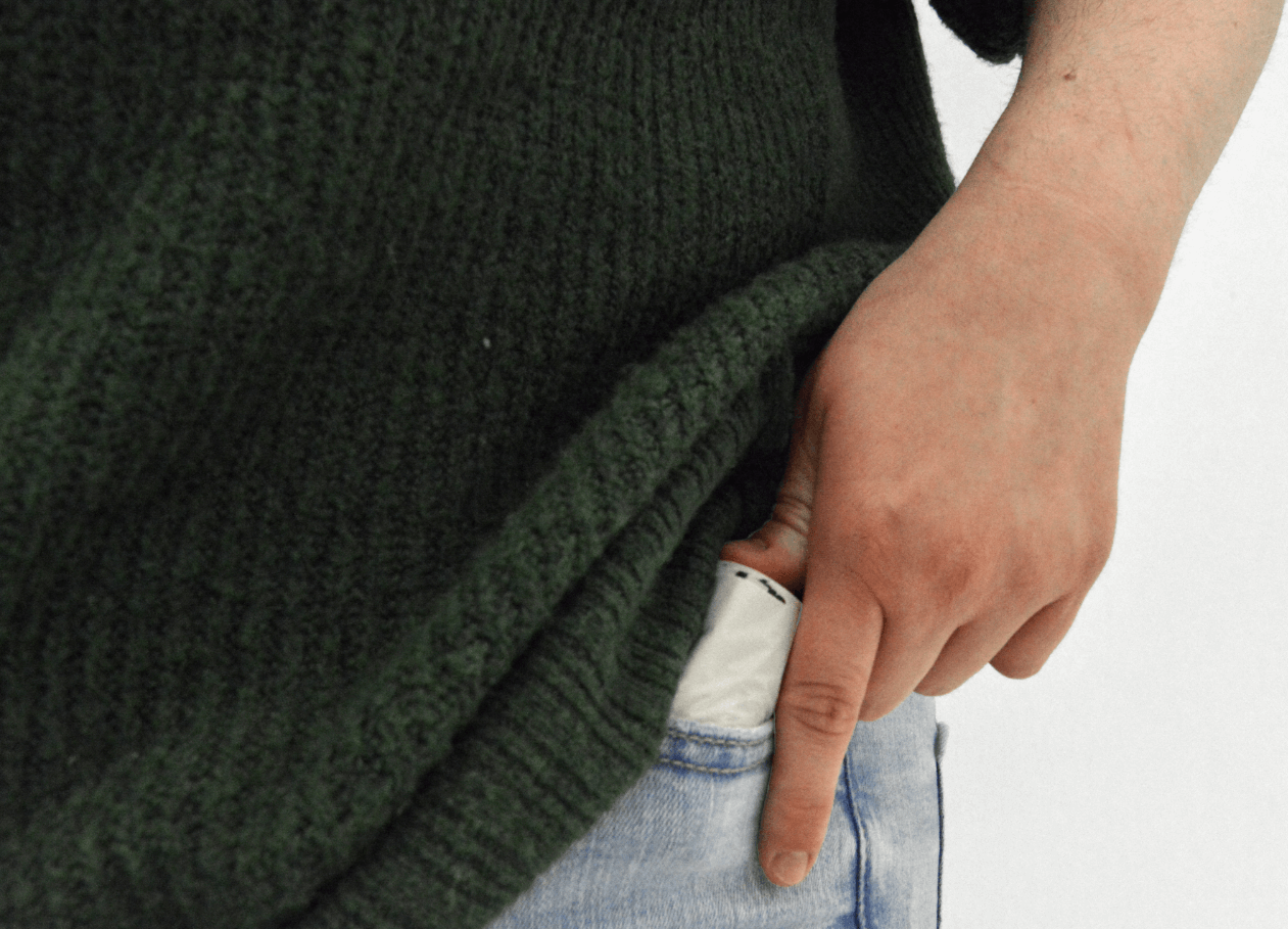 Person putting a roll of MyEcoWorld poop bags into their pocket.