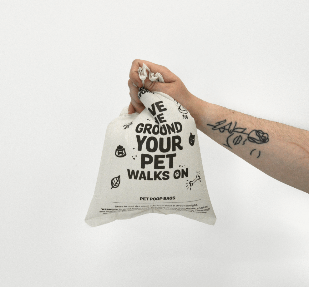 Hand holding MyEcoWorld poop bag filled with air.