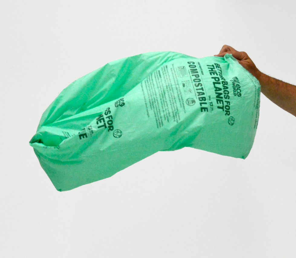 13 gallon MyEcoWorld Bag being held by a hand flowing in wind.